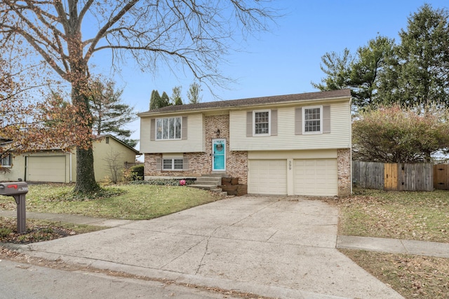 raised ranch with a front lawn and a garage