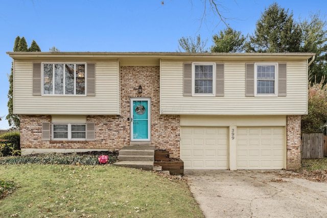 raised ranch with a front yard and a garage