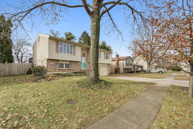 raised ranch with a front yard and a garage