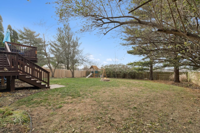 view of yard with a playground and a deck