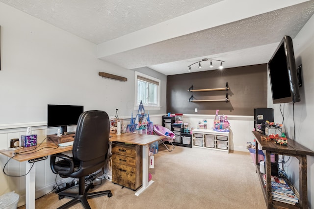 carpeted office space featuring a textured ceiling