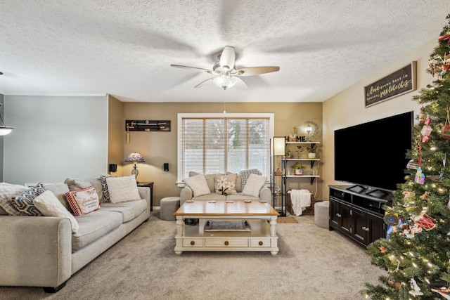 carpeted living room featuring ceiling fan and a textured ceiling