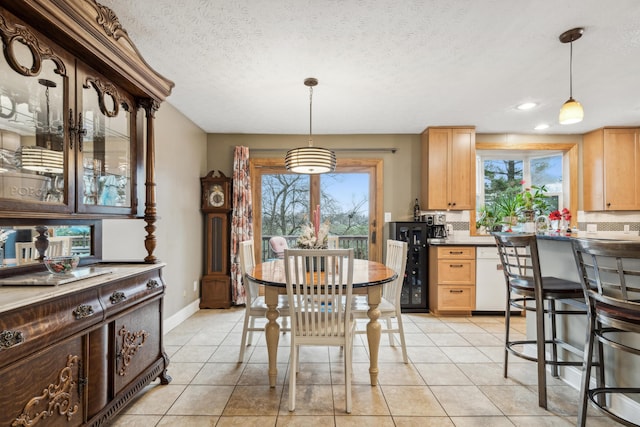 tiled dining room with a textured ceiling