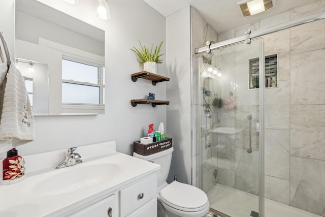 bathroom with vanity, an enclosed shower, and toilet