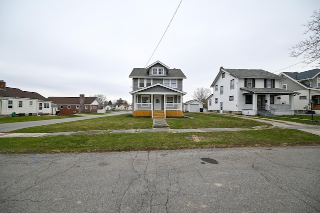 view of front facade featuring a front lawn, covered porch, and a garage