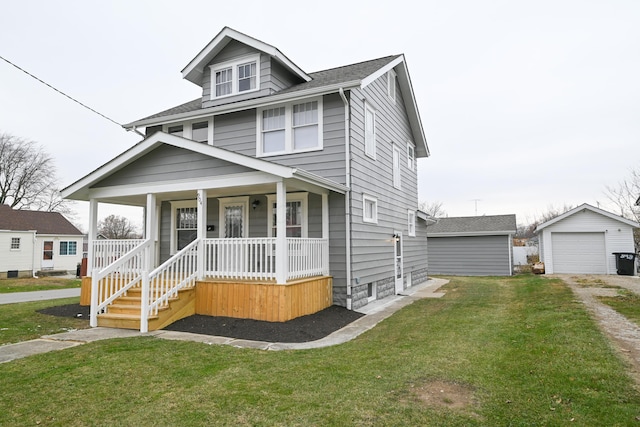 view of front of home featuring a front lawn, covered porch, an outdoor structure, and a garage