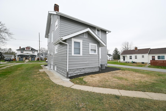 view of property exterior featuring a lawn