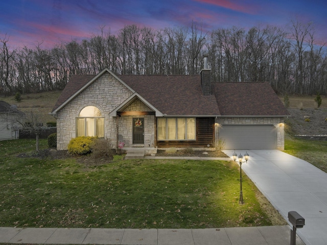 view of front of home with a lawn and a garage