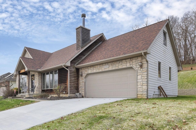 view of front of property featuring a garage and a front lawn