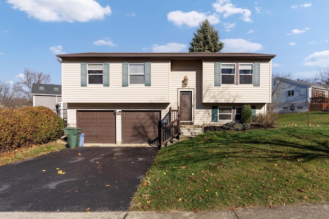 bi-level home with a front lawn and a garage