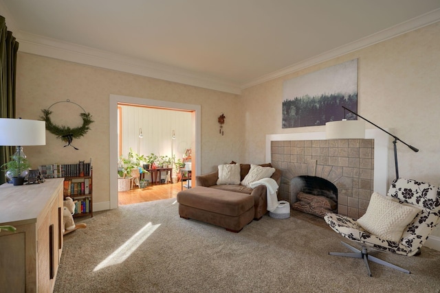 living room with carpet flooring, crown molding, and a tiled fireplace