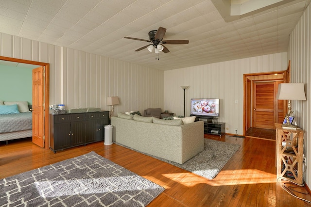 living room with dark hardwood / wood-style floors and ceiling fan