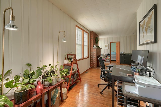 office featuring a fireplace and light hardwood / wood-style floors