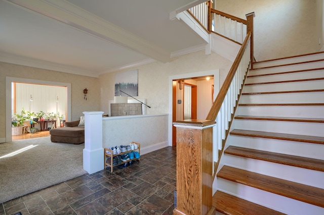 stairs featuring carpet flooring, beamed ceiling, and ornamental molding