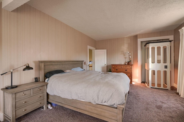 bedroom with carpet floors and a textured ceiling