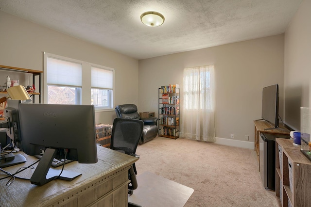 home office featuring light colored carpet and a textured ceiling