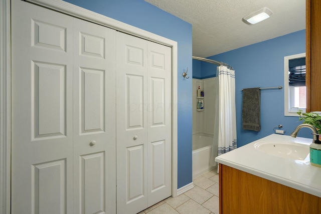 bathroom with vanity, shower / bath combination with curtain, and a textured ceiling