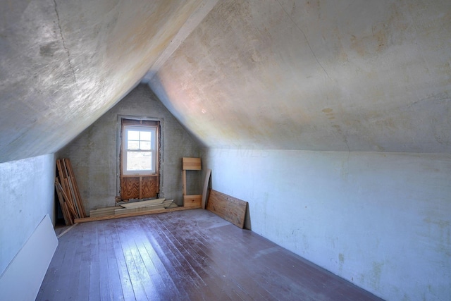 bonus room with dark hardwood / wood-style flooring and lofted ceiling