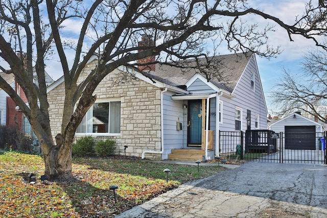 bungalow-style house with an outdoor structure and a garage