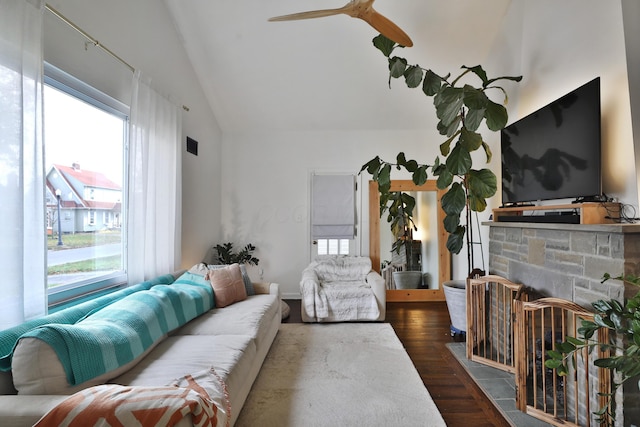 living room with ceiling fan, dark hardwood / wood-style flooring, and lofted ceiling