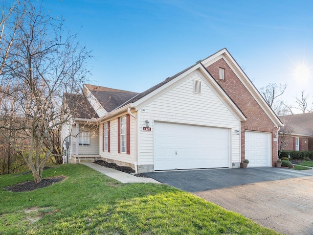 single story home with a front yard and a garage