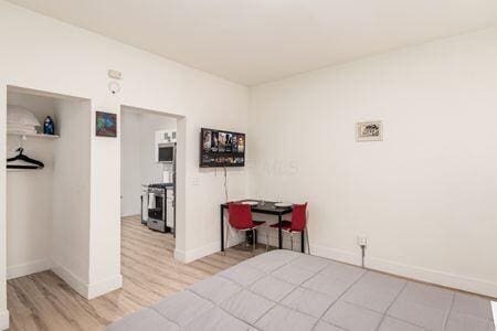 bedroom with light hardwood / wood-style flooring