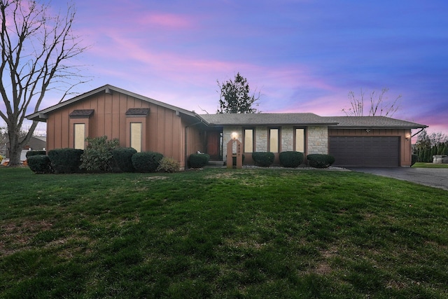 ranch-style house with a lawn and a garage