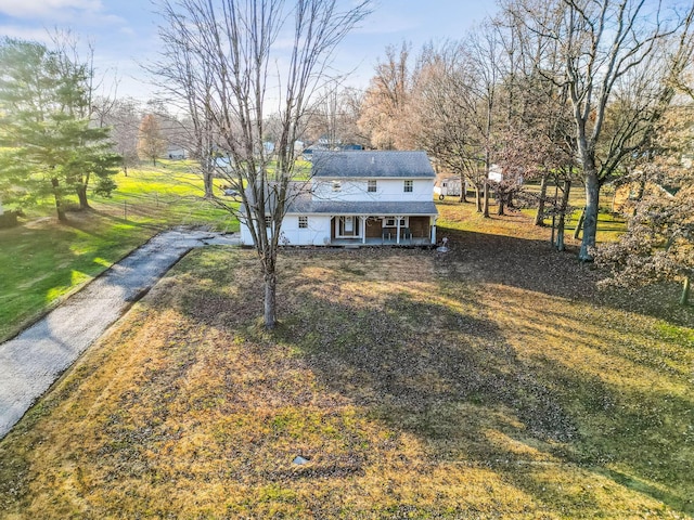 view of front of house with covered porch and a front yard