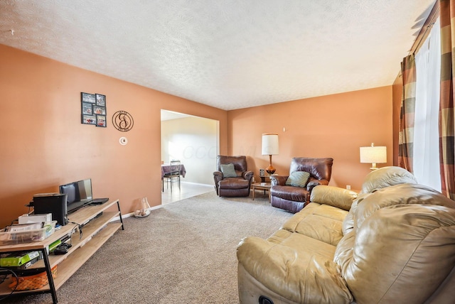 carpeted living room featuring a textured ceiling