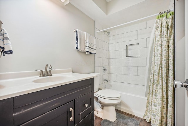 full bathroom featuring hardwood / wood-style flooring, vanity, toilet, and shower / tub combo with curtain