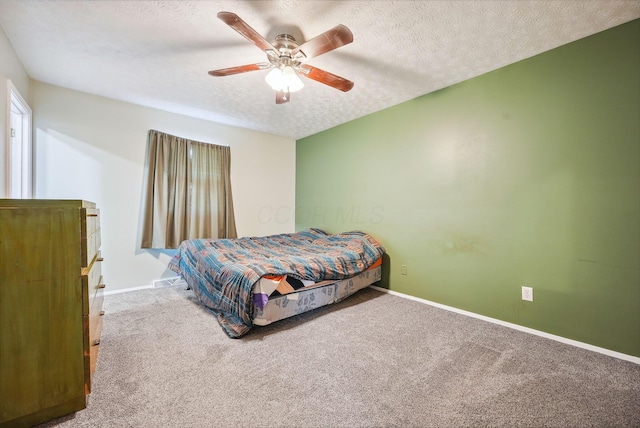 bedroom with carpet, ceiling fan, and a textured ceiling