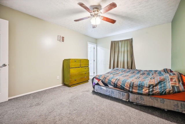 carpeted bedroom featuring a textured ceiling and ceiling fan