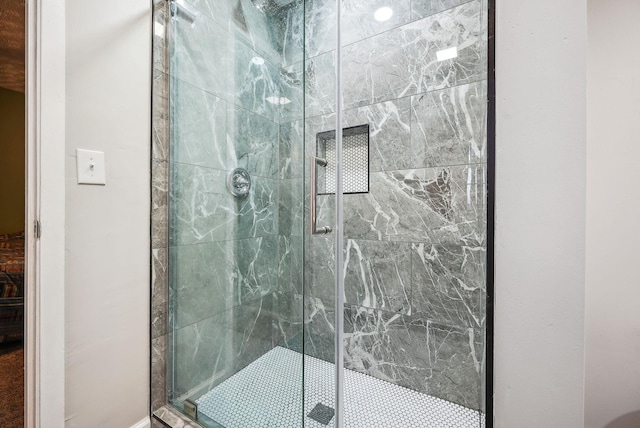 bathroom featuring a shower with door