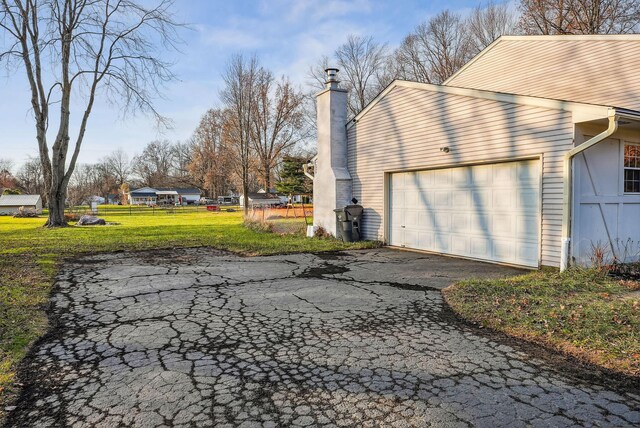 view of home's exterior with a lawn and a garage