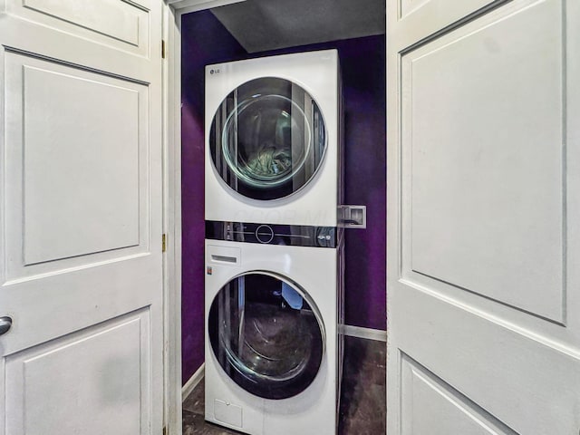 laundry area with stacked washer / drying machine