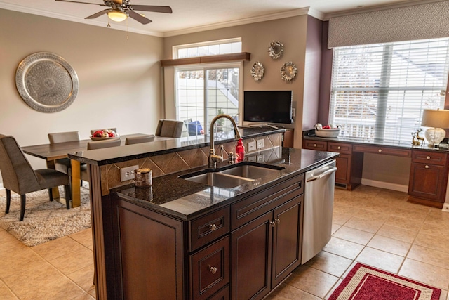 kitchen with stainless steel dishwasher, crown molding, sink, and an island with sink