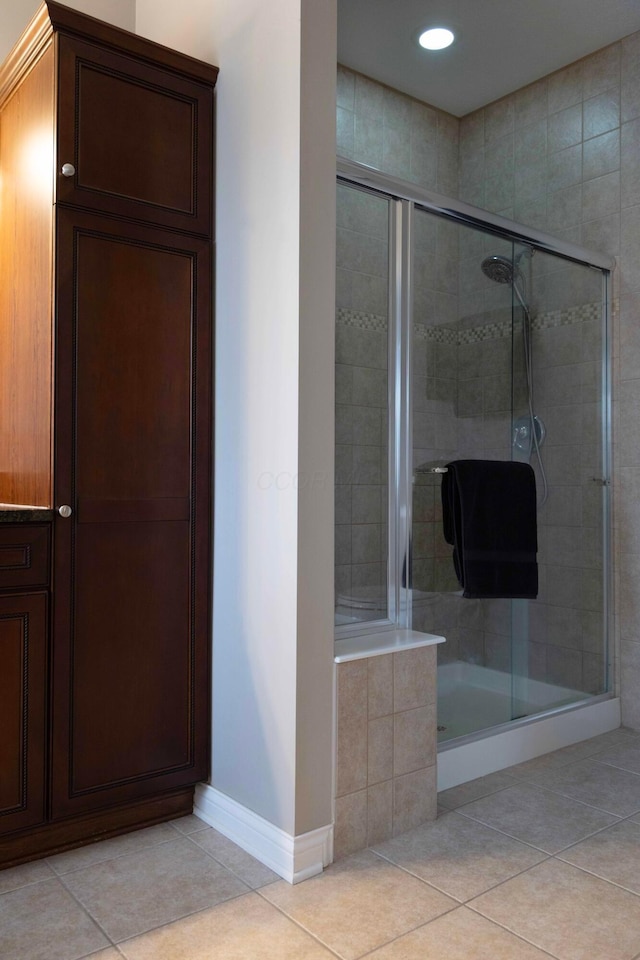 bathroom with tile patterned flooring and a shower with shower door