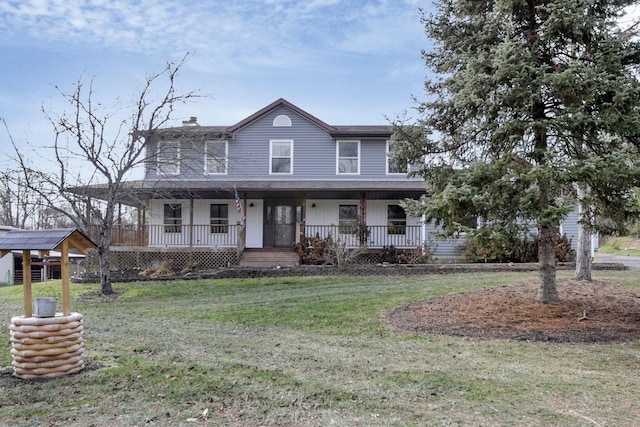 farmhouse inspired home featuring covered porch and a front yard