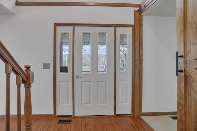 foyer entrance with light hardwood / wood-style floors