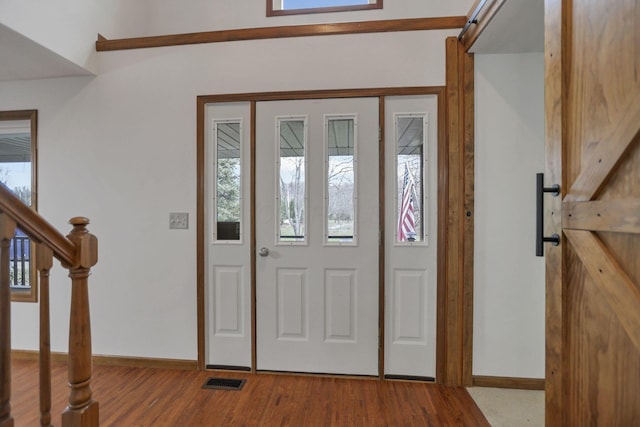 entrance foyer featuring light hardwood / wood-style floors and a barn door