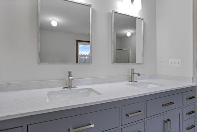 bathroom featuring vanity and a shower with shower door