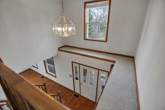 entryway with hardwood / wood-style floors and a chandelier