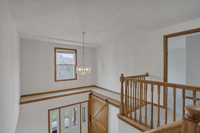 hall featuring a notable chandelier