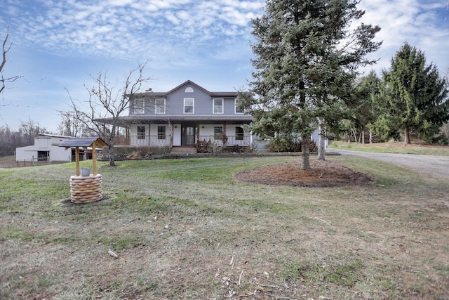 farmhouse inspired home with a front yard and a porch