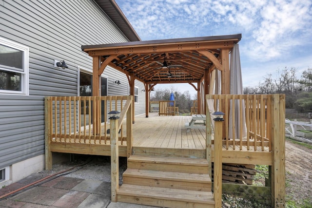 wooden deck featuring ceiling fan