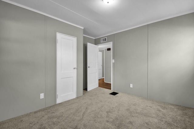 unfurnished bedroom featuring carpet and crown molding