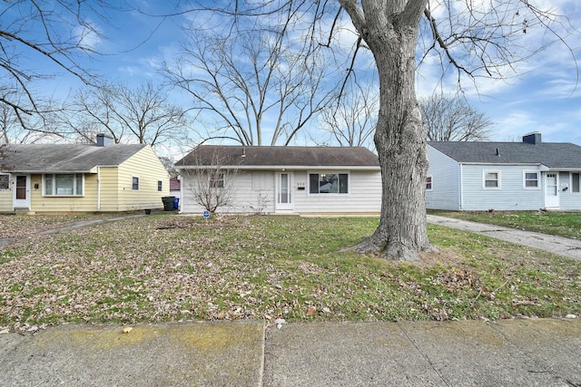 ranch-style home with a front lawn