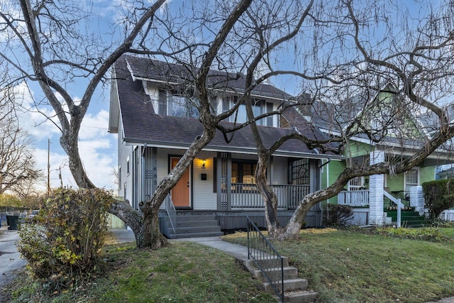 view of front facade with covered porch and a front yard