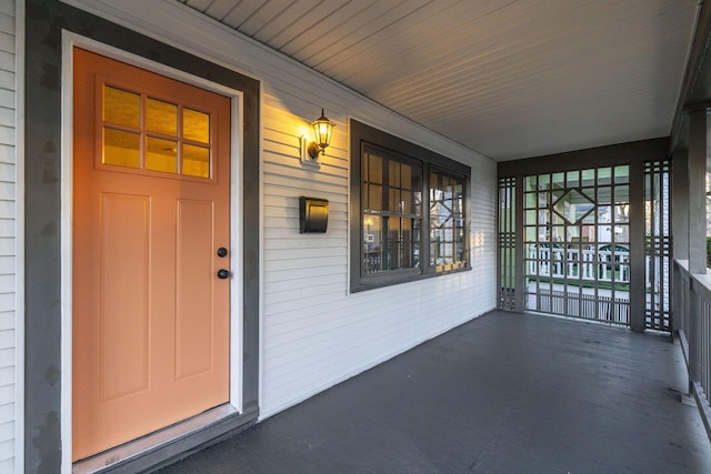 view of exterior entry featuring a porch