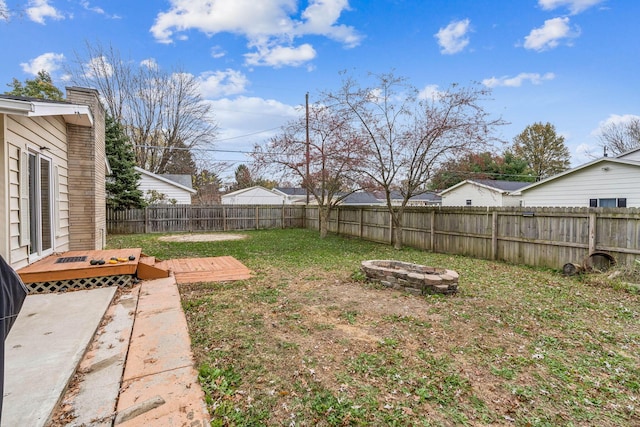 view of yard with a fire pit and a deck